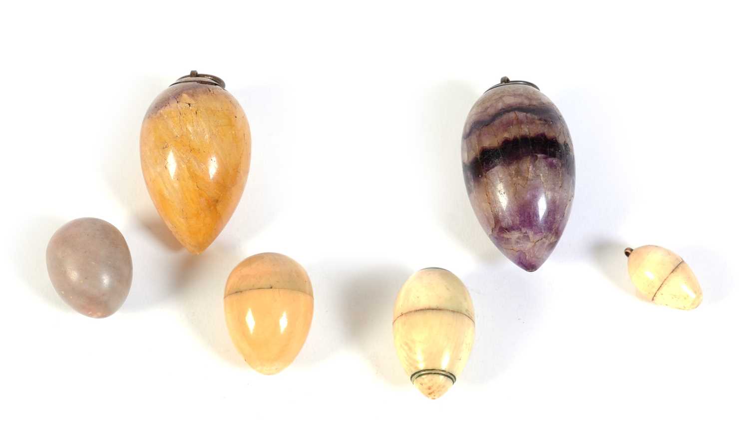 Lot 217 - Six egg-shaped pendants, various.