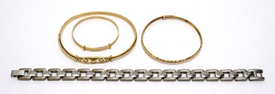Lot 205 - Three yellow metal bracelets and a titanium bracelet