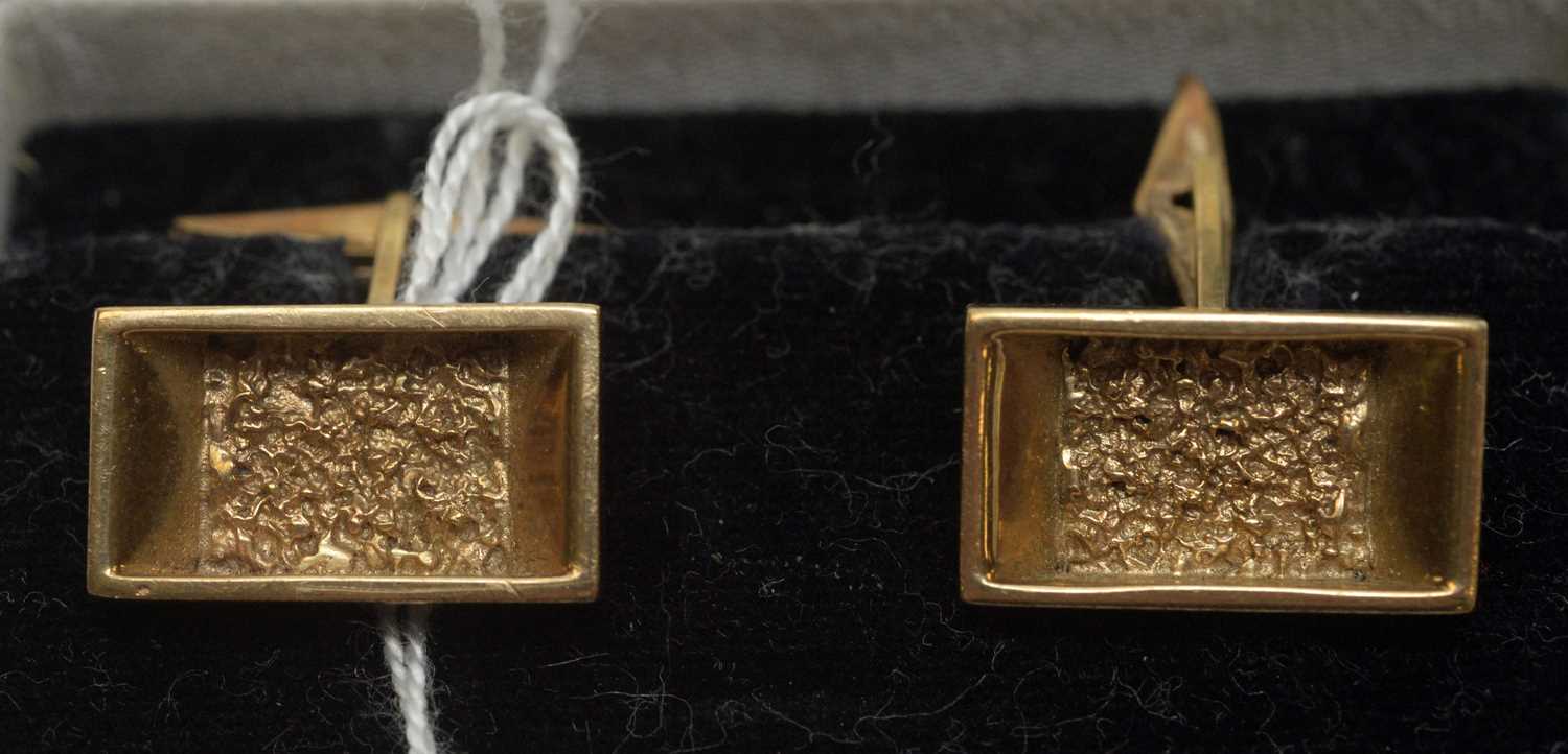 Lot 244 - A pair of 9ct. yellow gold cufflinks with textured design.