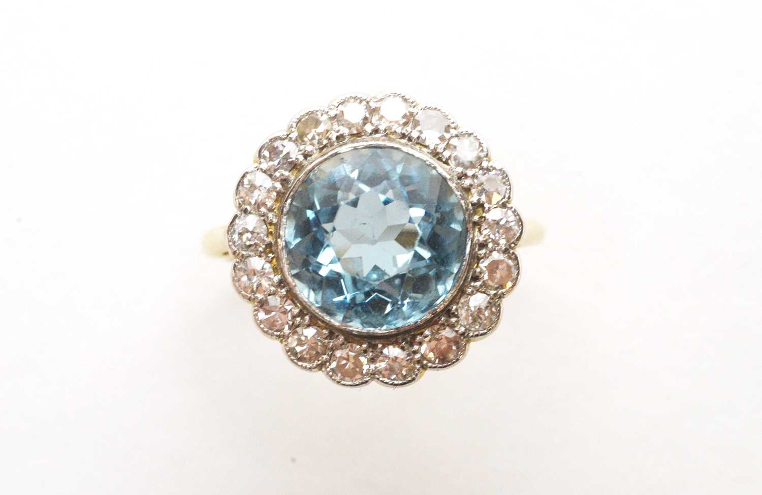 Lot 62 - An Aquamarine and diamond cluster ring