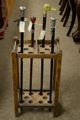 Lot 316 - Two silver topped walking sticks, two others and a stick stand