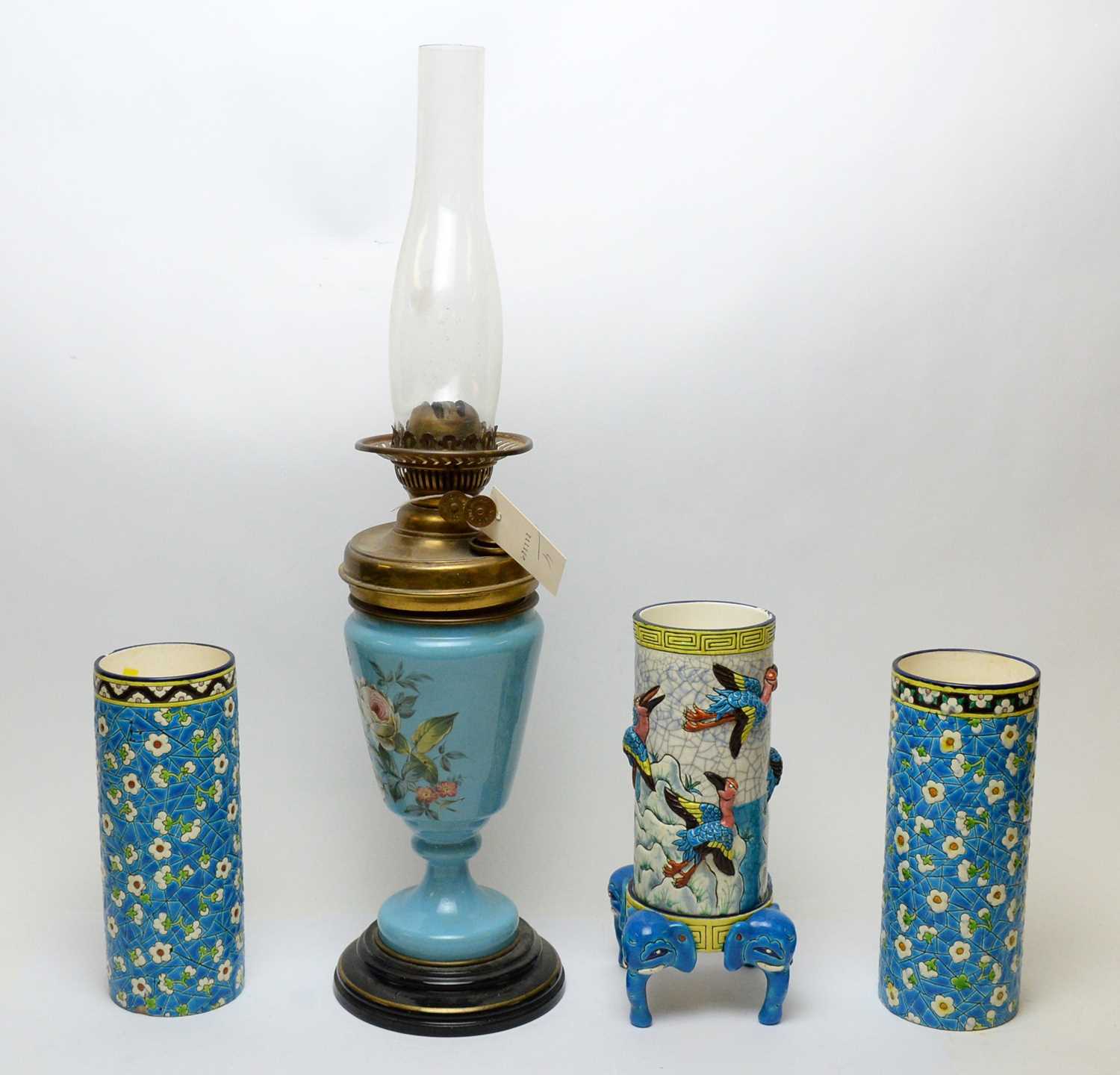 Lot 493 - A brass oil lamp and three vases.