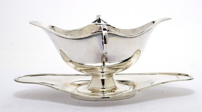 Lot 177 - An Edwardian silver two handled sauce boat on stand