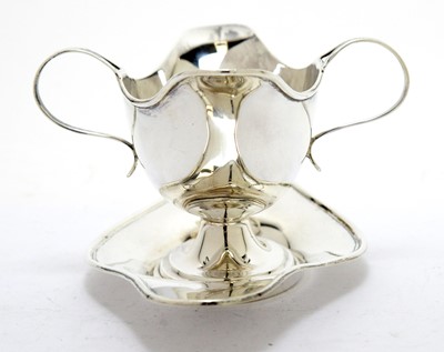 Lot 177 - An Edwardian silver two handled sauce boat on stand