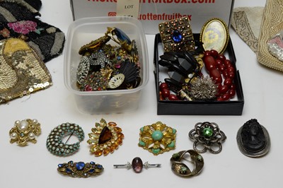 Lot 235 - A collection of vintage costume jewellery brooches and beaded evening bags.