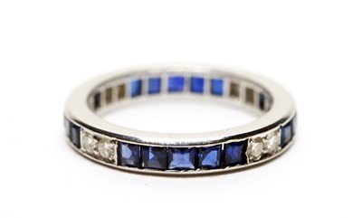 Lot 2 - A diamond and sapphire eternity ring