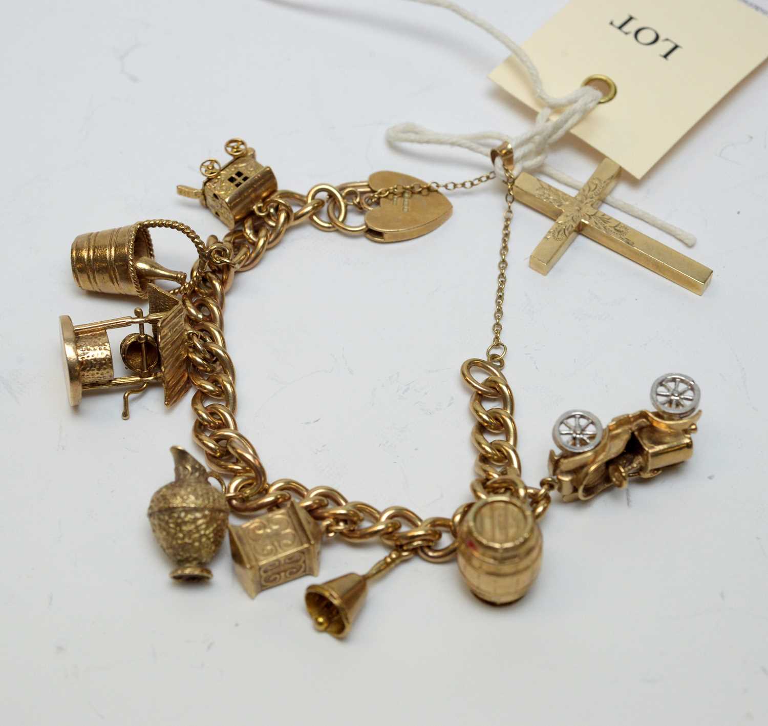 Lot 155 - A 9ct gold charm bracelet and gold charms, and a 9ct gold cruciform pendant.