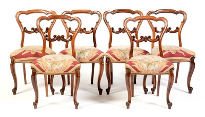 Lot 522 - A set of six Victorian carved rosewood balloon back dining chairs