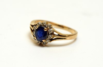 Lot 163 - A sapphire and diamond flowerhead cluster dress ring.