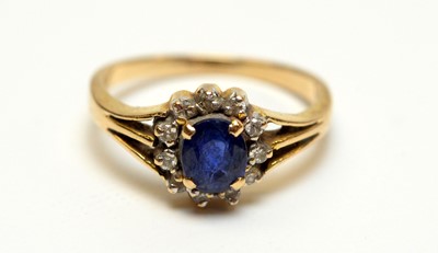 Lot 163 - A sapphire and diamond flowerhead cluster dress ring.
