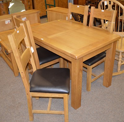 Lot 122 - A 20th Century oak extending dining table and four chairs