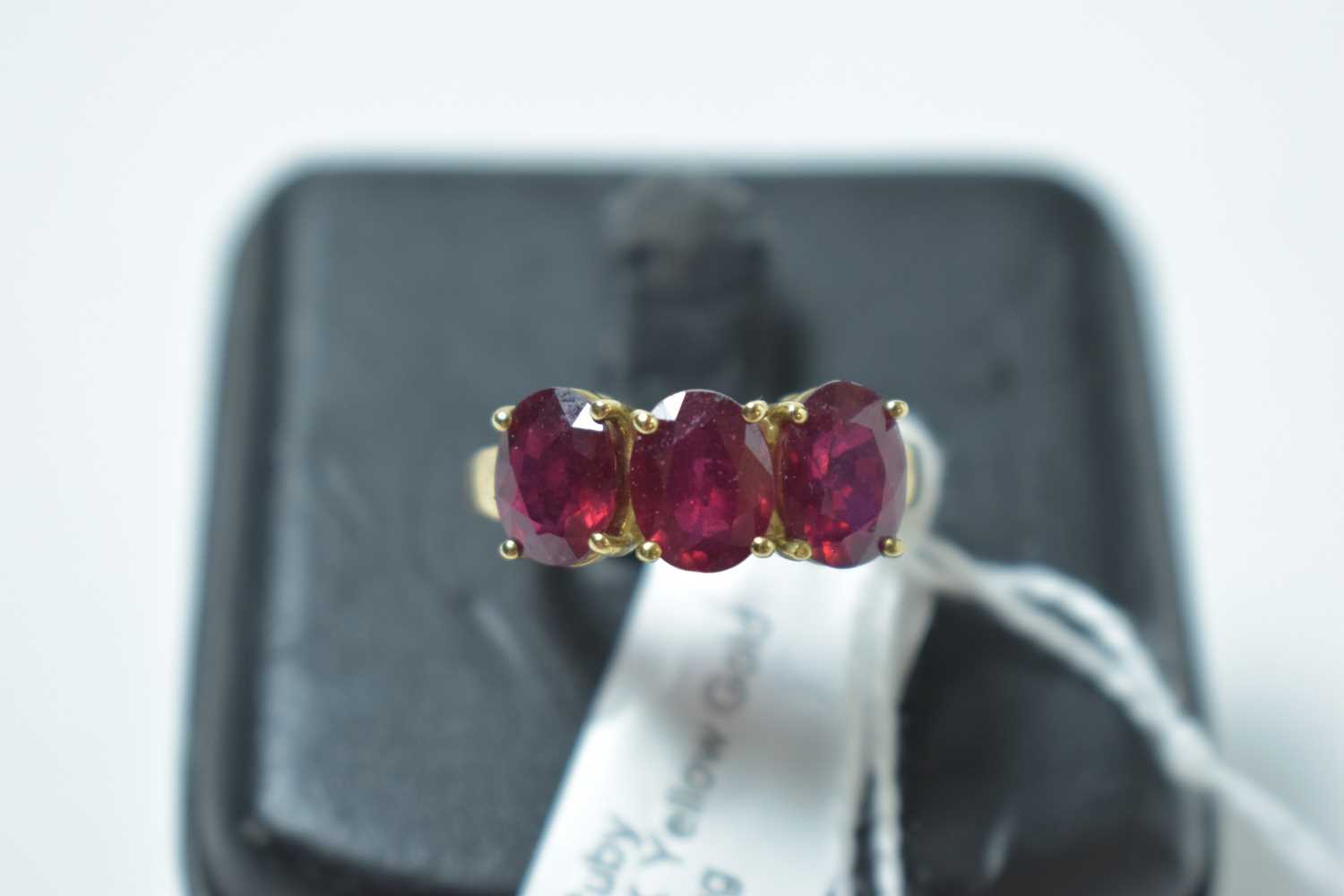 Lot 229 - A contemporary 9ct gold and ruby three stone ring
