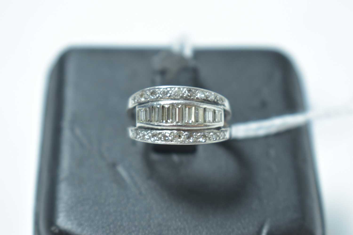 Lot 222 - A vintage platinum and diamond half hoop eternity ring.