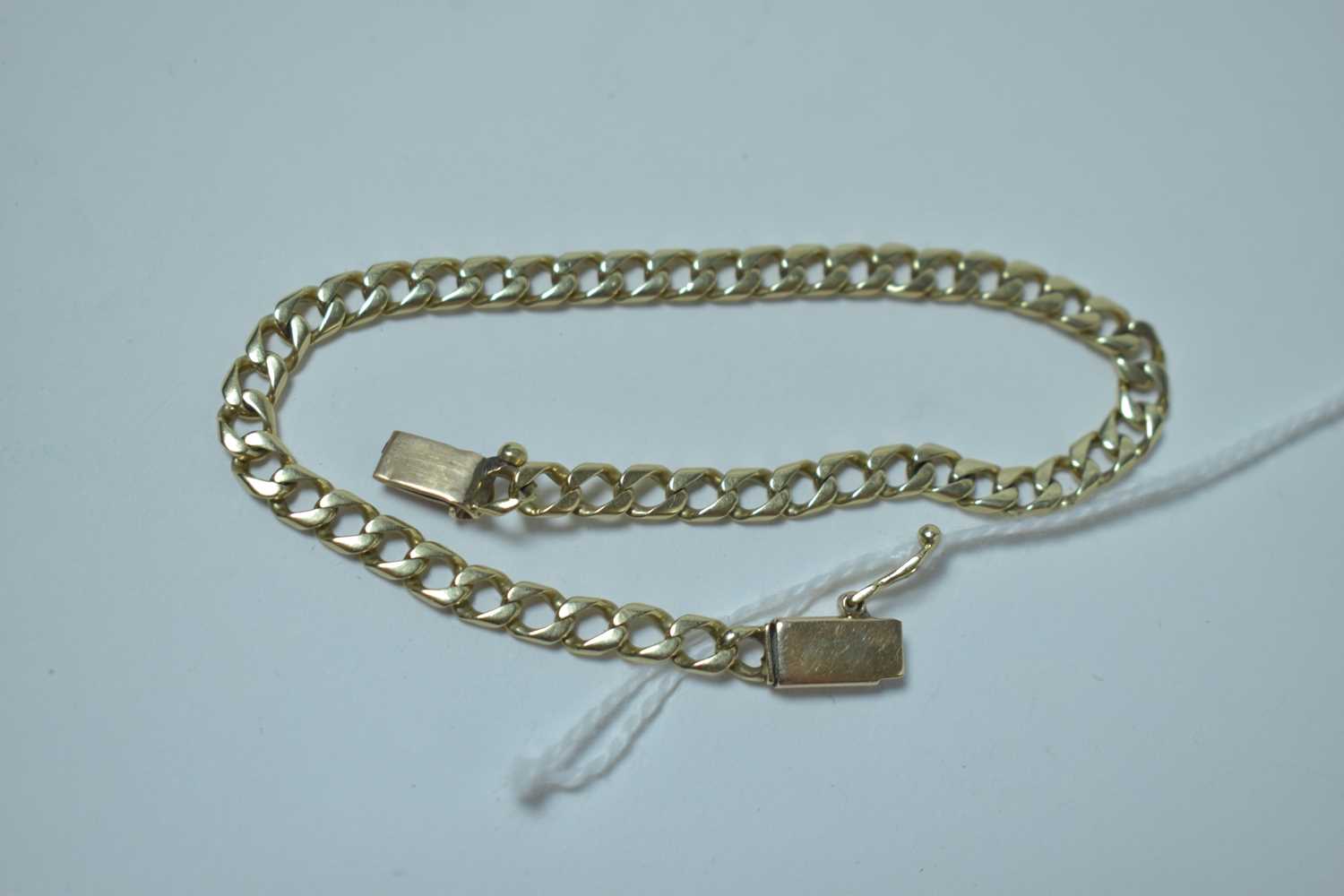 Lot 214 - A yellow metal curb link bracelet