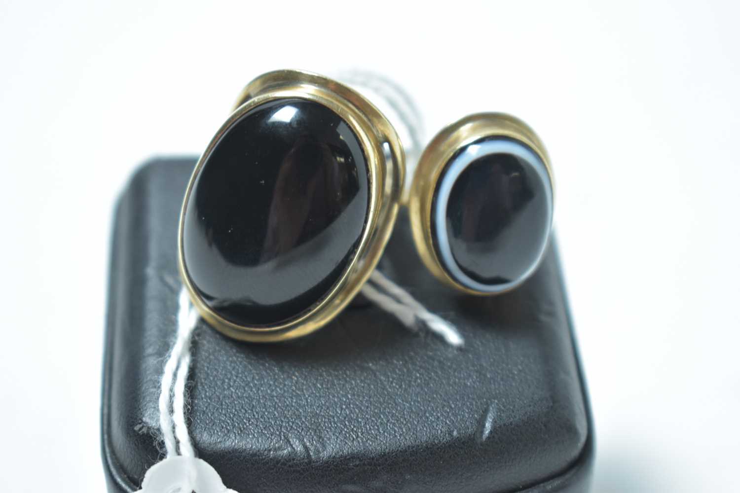 Lot 220 - A banded agate ring and an onyx ring