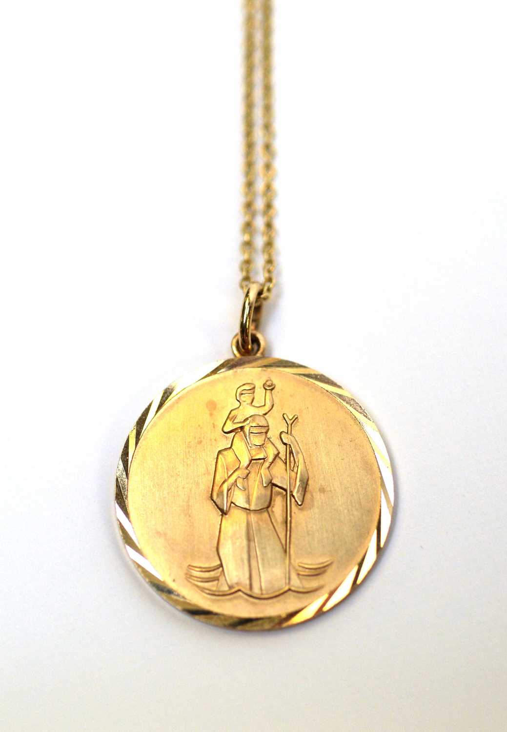 Lot 6 - A 9ct gold St. Christopher pendant on chain.