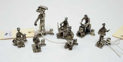 Lot 90 - A set of seven Elizabeth II silver "Cries of London" figural place card holders.
