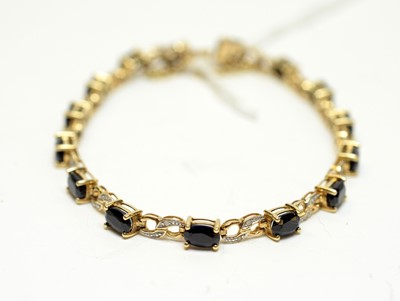 Lot 132 - A sapphire and diamond bracelet.