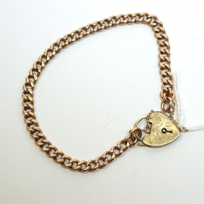 Lot 150 - A 9ct gold curb-link charm bracelet with heart-shaped padlock clasp.