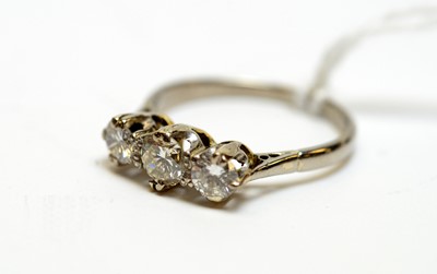 Lot 122 - A three-stone diamond ring.