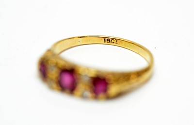 Lot 20 - A three-stone ruby and diamond dress ring.