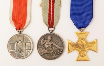 Lot 1119 - WWII German Police Long Service award; a Social Welfare decoration and a Deutsch Frei Die Saar medal.