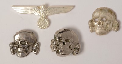 Lot 1049 - Three reproduction WWII SS Toten Kopf badges and a cap badge