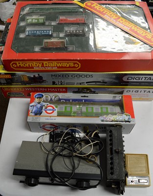 Lot 875 - Three boxed Hornby 00-gauge trains sets, and other items.