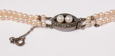 Lot 223 - An early 20th Century diamond, pearl, and yellow-metal bar brooch.