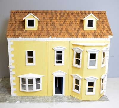 Lot 957 - A doll's house incorporating a shop to one side.