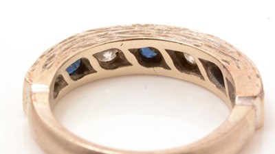 Lot 85 - A sapphire and diamond half hoop ring