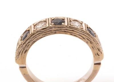 Lot 85 - A sapphire and diamond half hoop ring