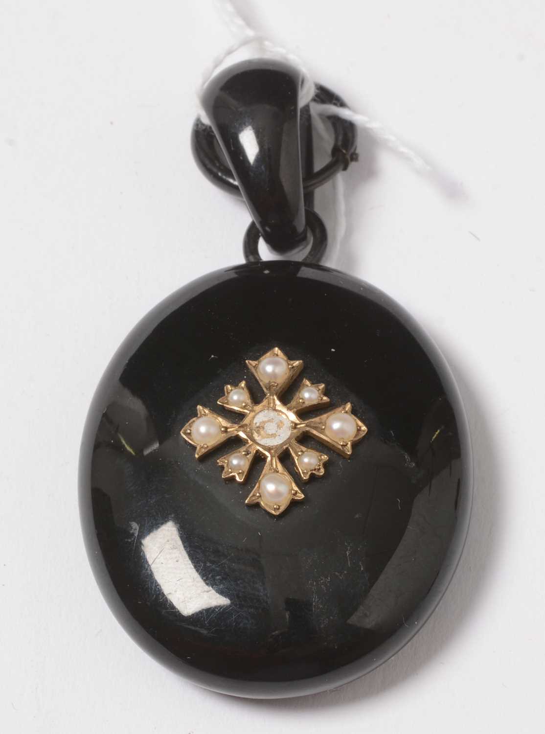 Lot 263 - A Victorian jet and seed pearl pendant locket.