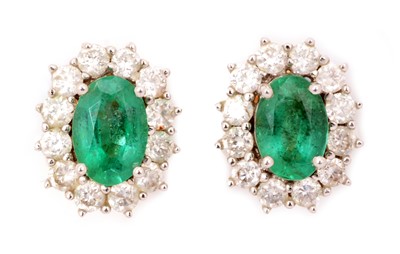 Lot 88 - A pair of emerald and diamond cluster earrings