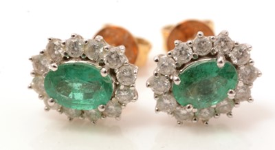 Lot 88 - A pair of emerald and diamond cluster earrings