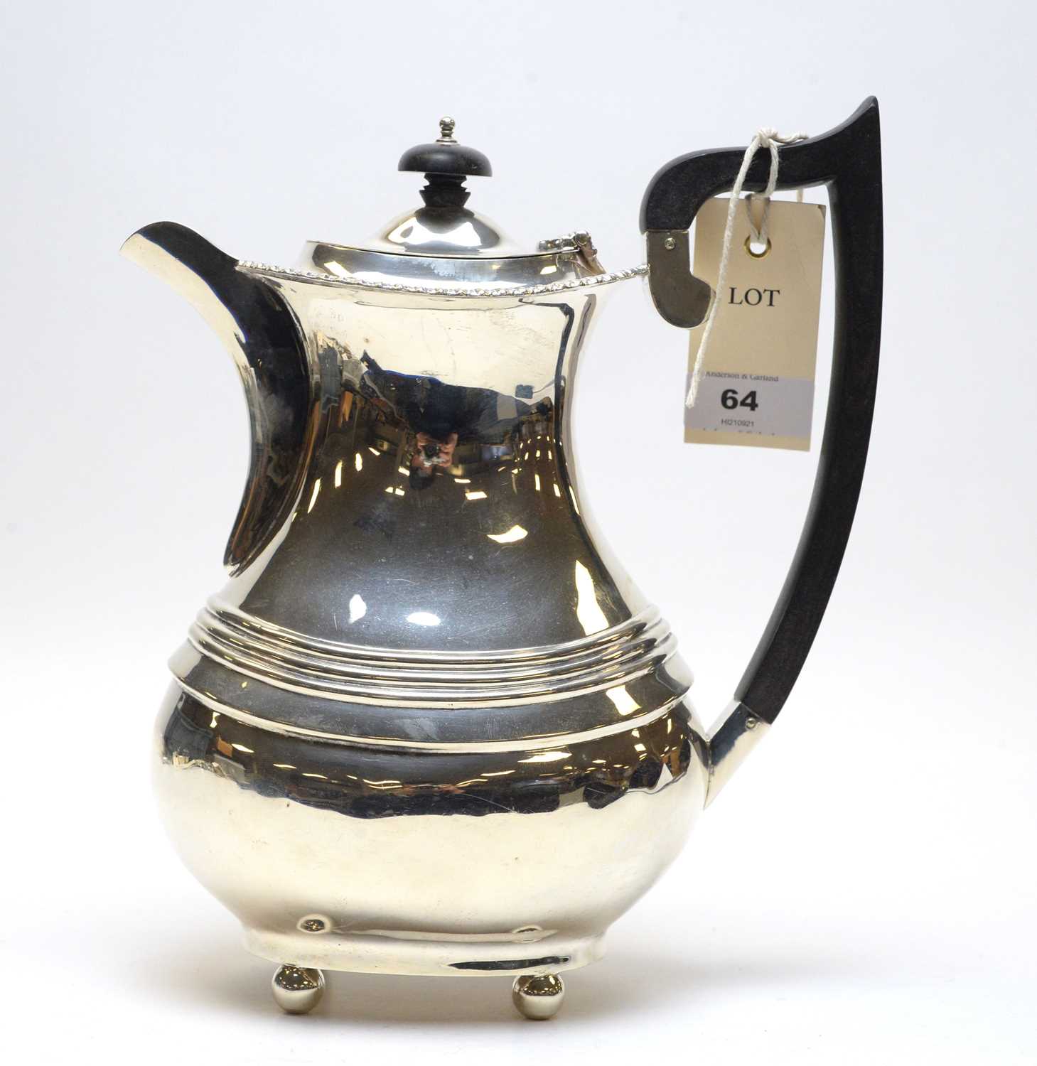 Lot 64 - A George V silver coffee pot.