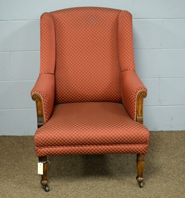Lot 38 - An early 20th Century wing back armchair.