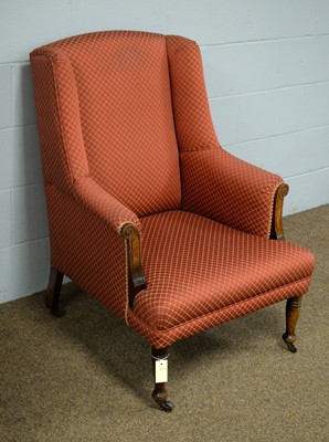 Lot 38 - An early 20th Century wing back armchair.