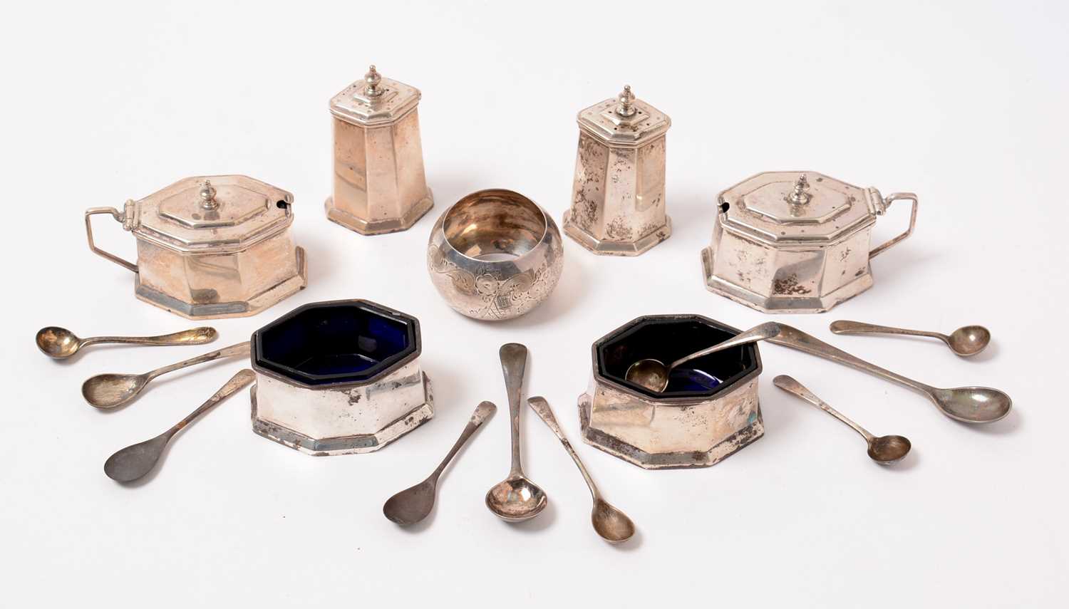 Lot 192 - A George V six-piece Art Deco silver cruet set, a napkin ring, and spoons.