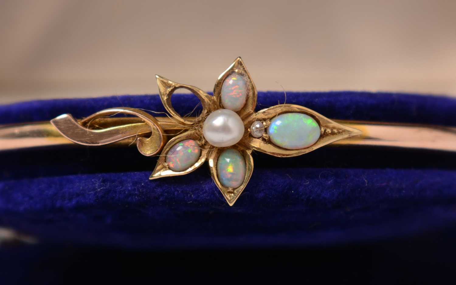 Lot 222 - An Edwardian opal, diamond, and pearl bangle.
