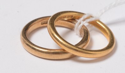 Lot 244 - Two gold and yellow metal wedding bands.