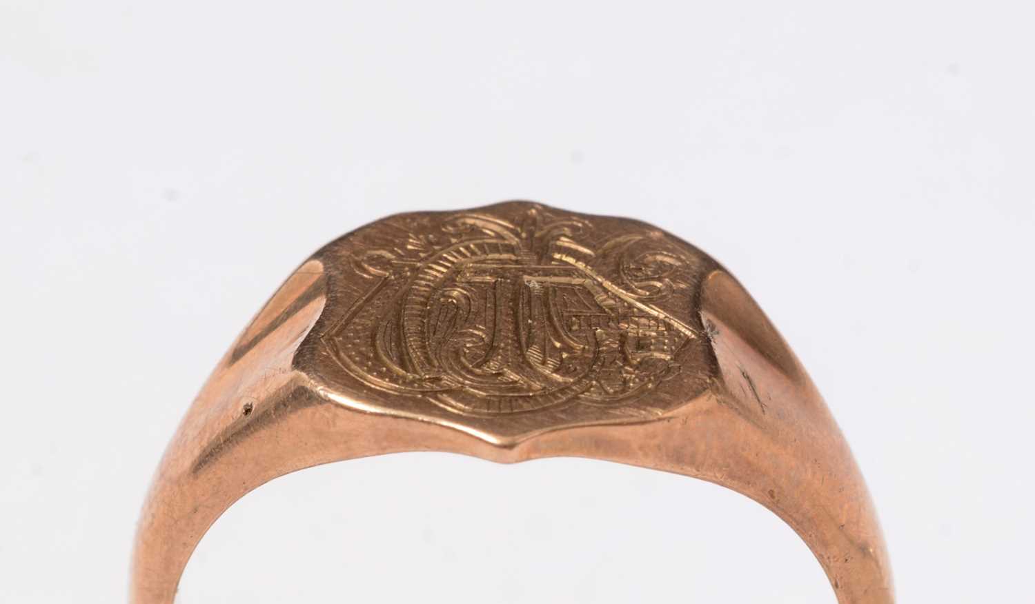 Lot 271 - A 9ct rose gold signet ring, the shield-shaped face engraved with a monogram.