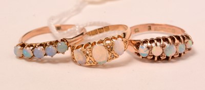 Lot 128 - Three opal, gold, and yellow-metal rings.