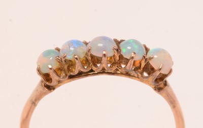 Lot 128 - Three opal, gold, and yellow-metal rings.