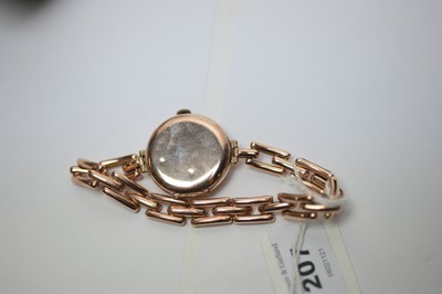 Lot 207 - A lady's 9ct rose gold wristwatch on a yellow-metal flexible bracelet strap.