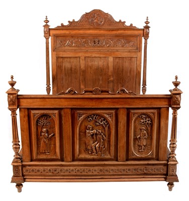 Lot 557 - A ornate French carved walnut bed