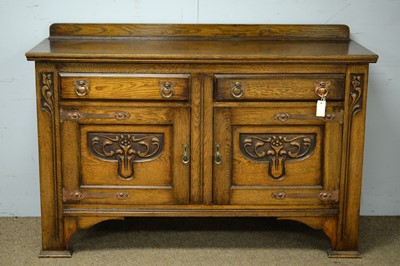 Lot 93 - An early 20th Century Arts & Crafts carved oak sideboard.