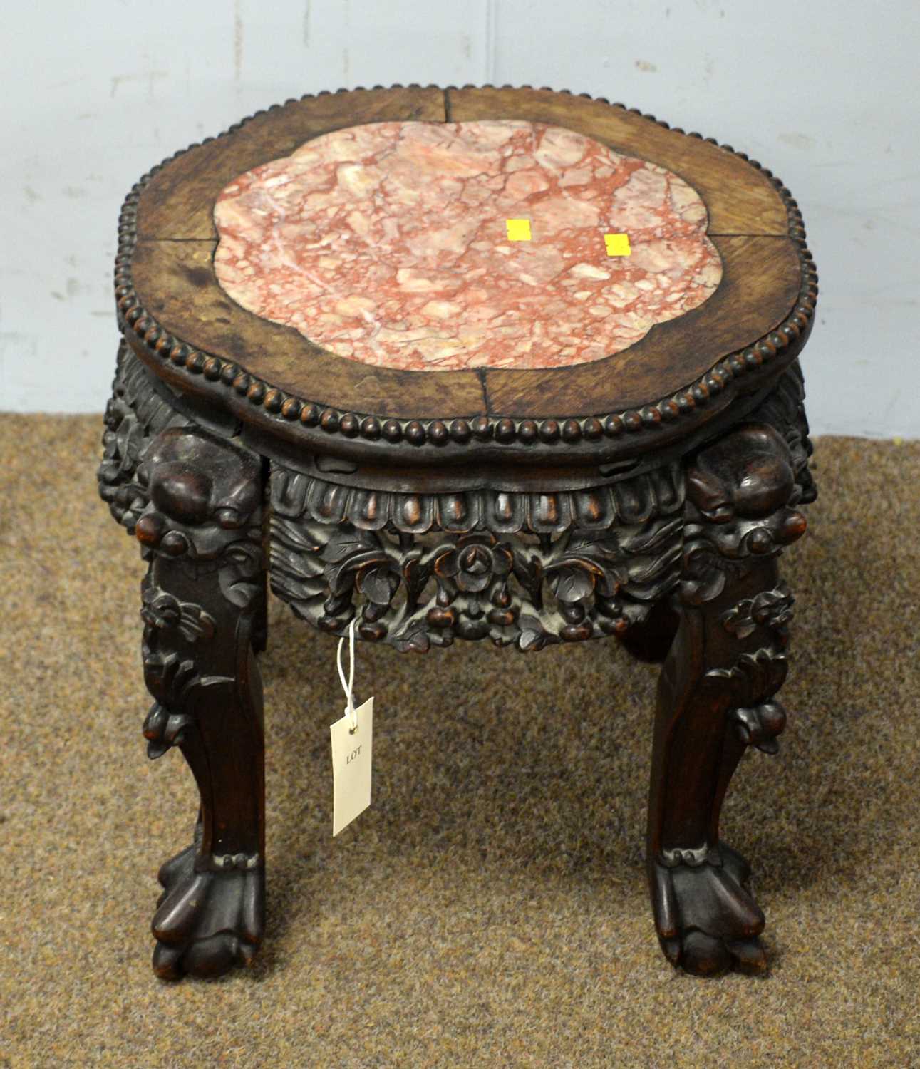 Lot 64 - A Chinese carved hardwood jardiniere stand.