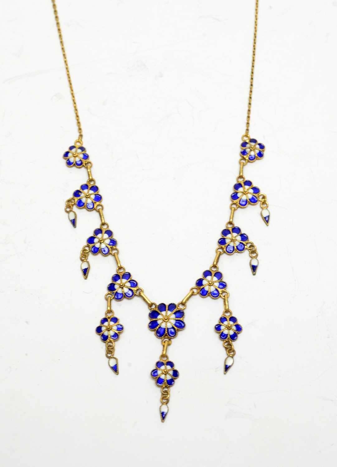 Lot 195 - An early 20th century yellow-metal and enamel forget-me-not necklace.