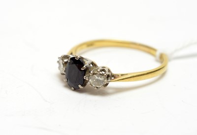 Lot 173 - A three-stone sapphire and diamond ring.